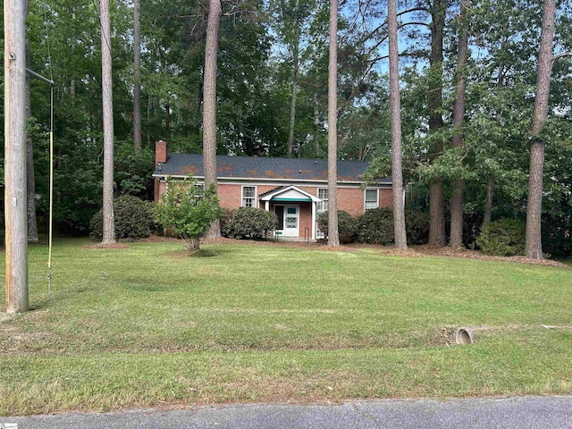 402 Chestnut St, Clinton, SC 29325 - view of front of house with brick siding, a front lawn, and a chimney