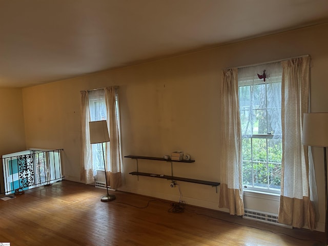 402 Chestnut St, Clinton, SC 29325 - empty room with plenty of natural light and wood finished floors