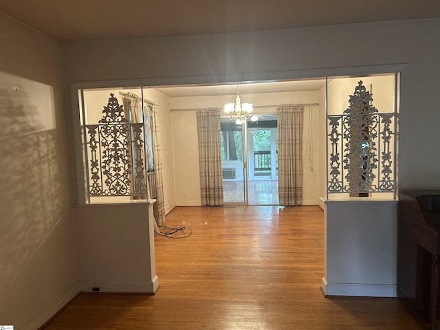 402 Chestnut St, Clinton, SC 29325 - unfurnished dining area featuring an inviting chandelier, baseboards, and wood finished floors