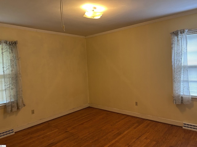 402 Chestnut St, Clinton, SC 29325 - unfurnished room featuring crown molding, plenty of natural light, wood finished floors, and visible vents