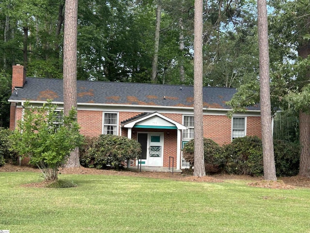 402 Chestnut St, Clinton, SC 29325 - view of front facade with brick siding, a chimney, and a front lawn