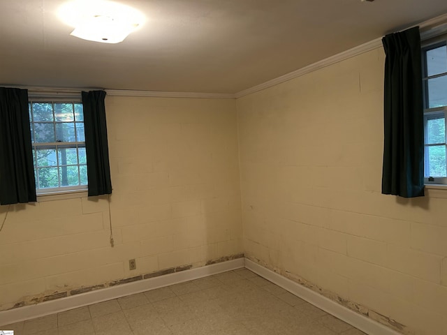 402 Chestnut St, Clinton, SC 29325 - unfurnished room featuring baseboards, ornamental molding, light floors, and concrete block wall