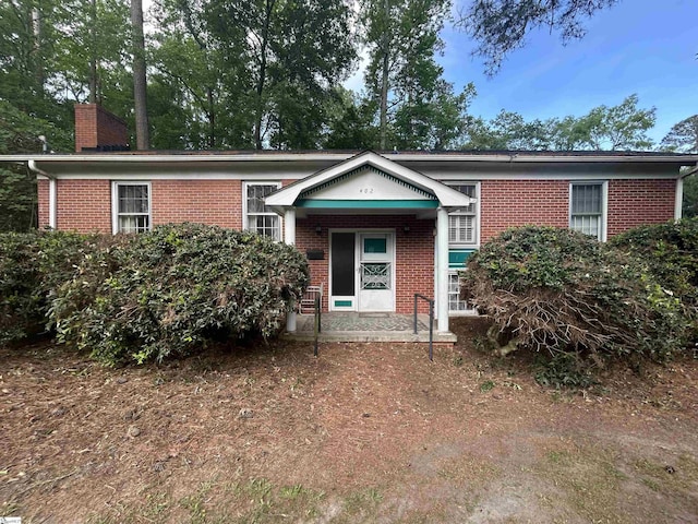 402 Chestnut St, Clinton, SC 29325 - view of front of property with brick siding and a chimney