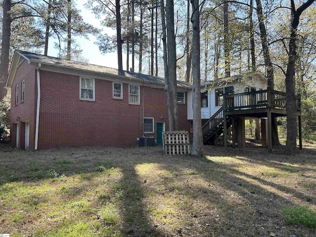 402 Chestnut St, Clinton, SC 29325 - back of property featuring an attached garage, brick siding, a wooden deck, stairway, and central air condition unit