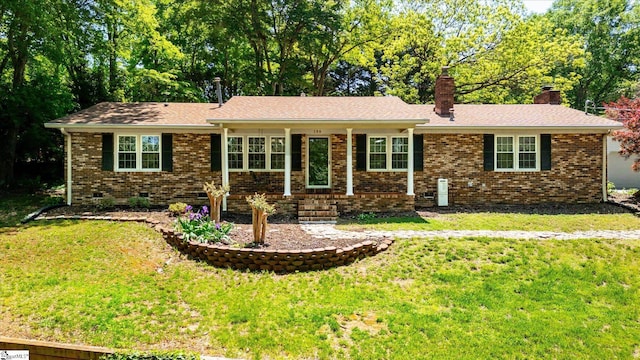 single story home with brick siding, a front lawn, and a chimney