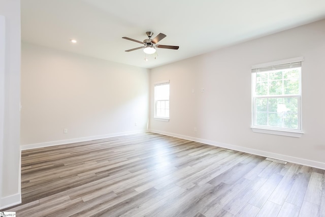 unfurnished room with baseboards, a ceiling fan, wood finished floors, and recessed lighting