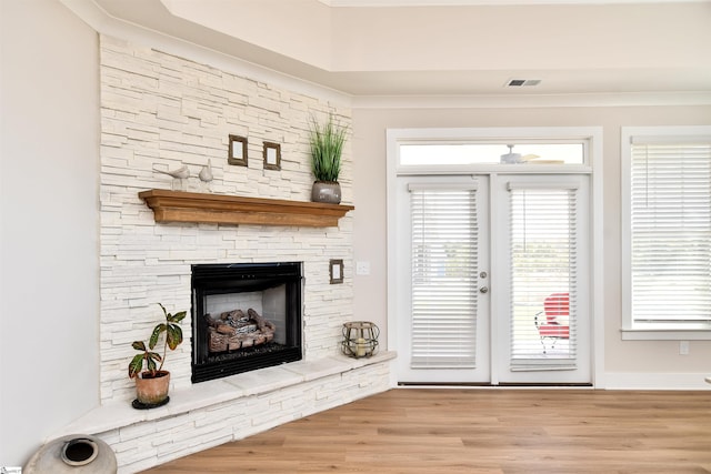 entryway with a fireplace, wood finished floors, and visible vents