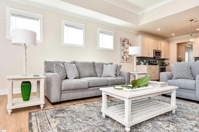 living room featuring recessed lighting, ornamental molding, and light wood-style flooring