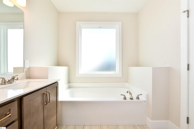 full bathroom with a garden tub and vanity