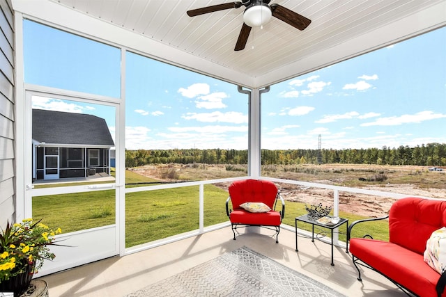 sunroom featuring ceiling fan