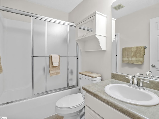 bathroom with toilet, visible vents, bath / shower combo with glass door, and vanity