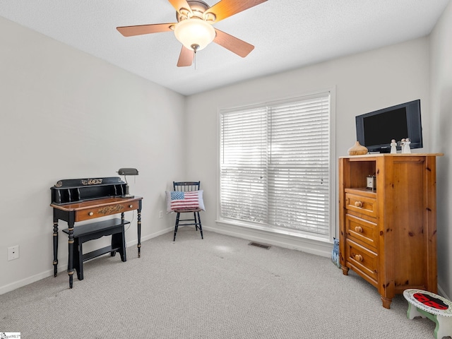 sitting room featuring carpet floors, baseboards, visible vents, and ceiling fan