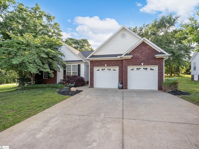 view of front of house with brick siding, driveway, a front lawn, and a garage