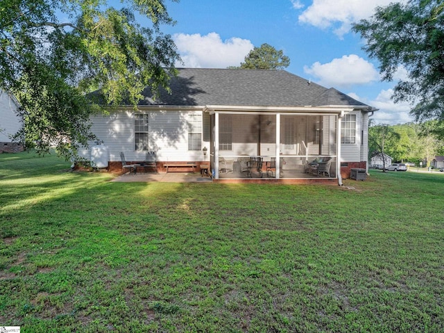rear view of house with a sunroom, a lawn, crawl space, and a patio