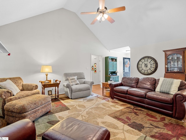 living area featuring ceiling fan and high vaulted ceiling