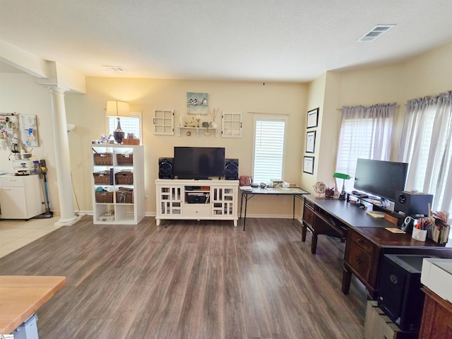 office area with ornate columns, visible vents, and plenty of natural light