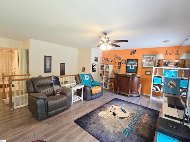 living room featuring a ceiling fan and wood finished floors