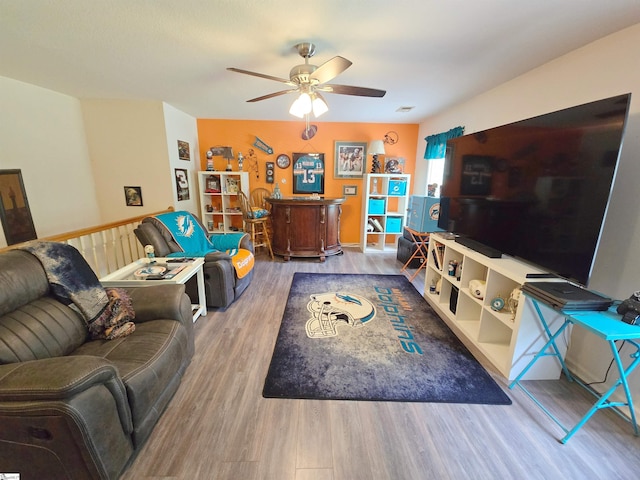 living room featuring ceiling fan and wood finished floors