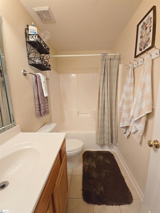 full bath with tile patterned flooring, vanity, toilet, a textured ceiling, and visible vents