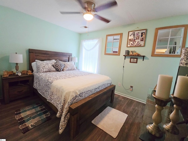 bedroom featuring visible vents, baseboards, ceiling fan, and wood finished floors