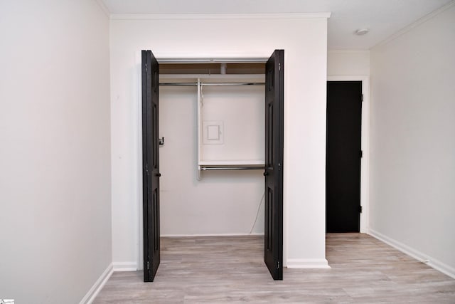 unfurnished bedroom featuring baseboards, ornamental molding, and wood finished floors