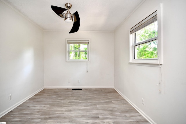 spare room with ceiling fan, ornamental molding, and wood finished floors