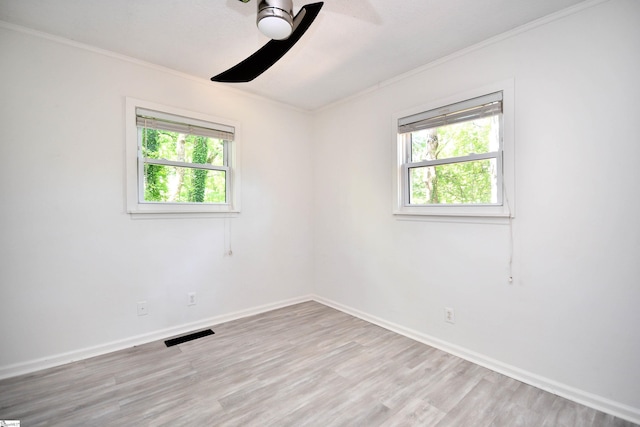 spare room featuring crown molding, a ceiling fan, and a healthy amount of sunlight