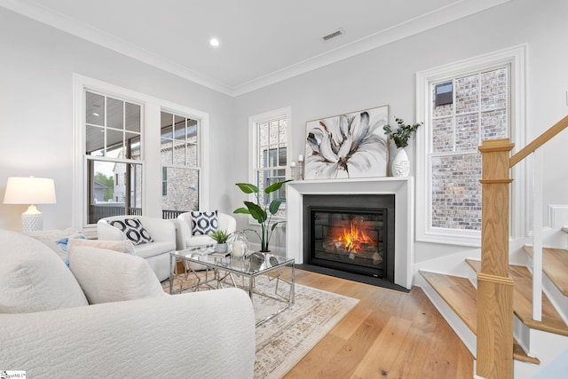 living area featuring stairs, recessed lighting, a fireplace with flush hearth, wood finished floors, and visible vents