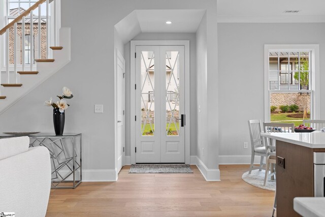 foyer with recessed lighting, baseboards, light wood-type flooring, and stairs