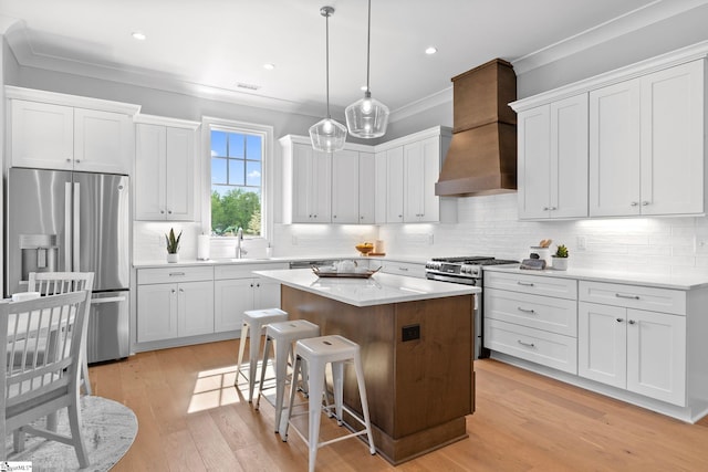 kitchen featuring a kitchen breakfast bar, a kitchen island, custom range hood, ornamental molding, and stainless steel appliances