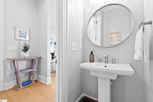 bathroom with baseboards and wood finished floors