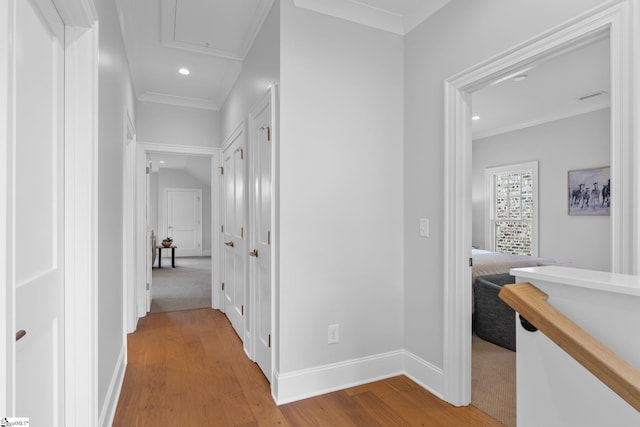 corridor featuring recessed lighting, ornamental molding, wood finished floors, and attic access