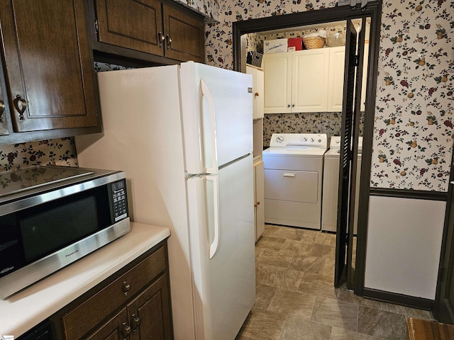 kitchen with stainless steel microwave, dark brown cabinets, and wallpapered walls