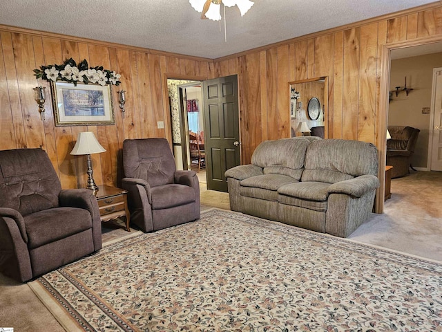 carpeted living room featuring wooden walls, crown molding, a textured ceiling, and ceiling fan