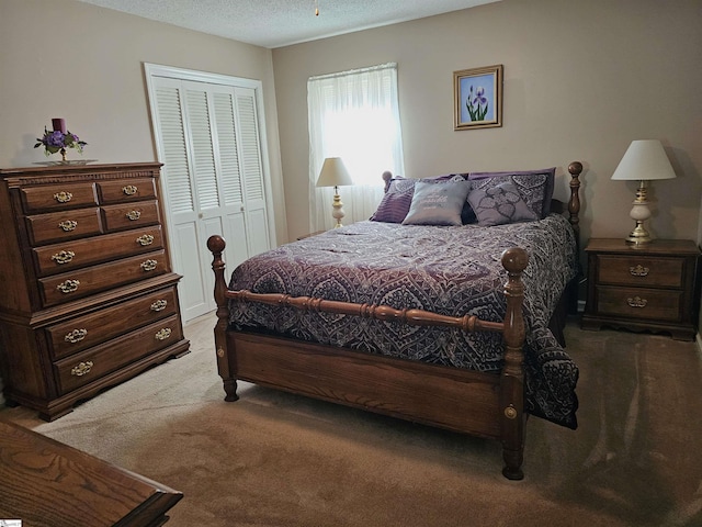 bedroom featuring a closet, a textured ceiling, and light colored carpet