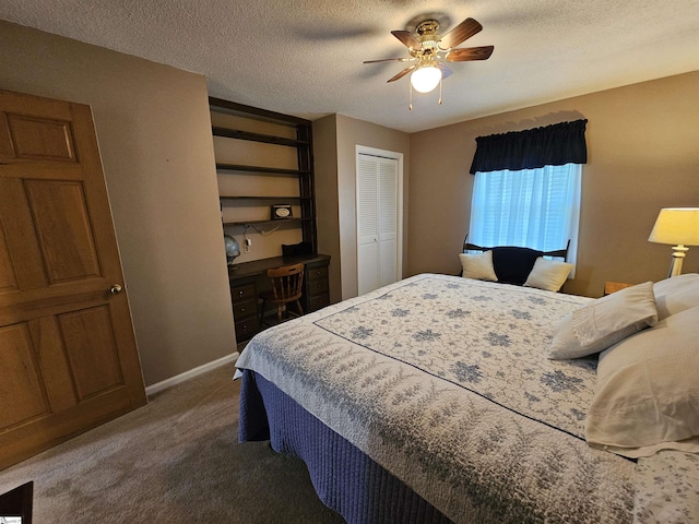 carpeted bedroom featuring baseboards, a ceiling fan, a textured ceiling, and built in study area