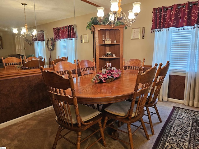 carpeted dining room with baseboards and a chandelier