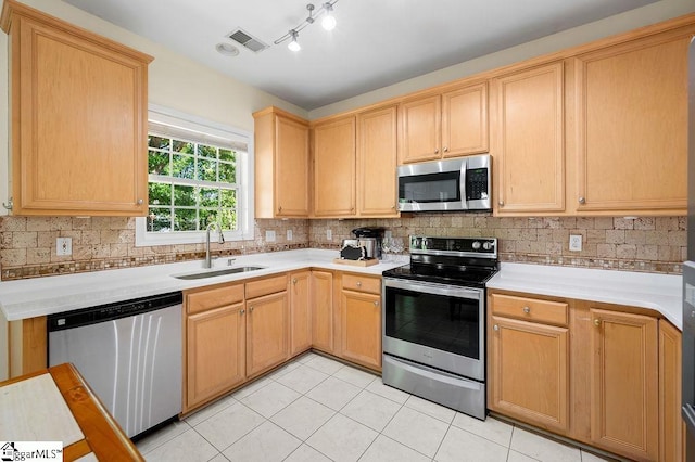 kitchen with visible vents, a sink, appliances with stainless steel finishes, and light countertops
