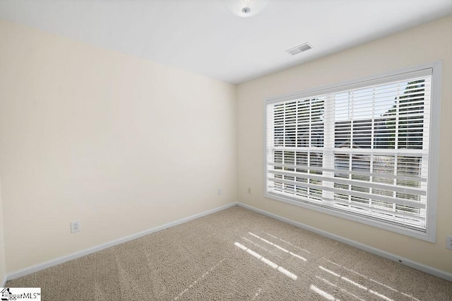 carpeted empty room with baseboards and visible vents