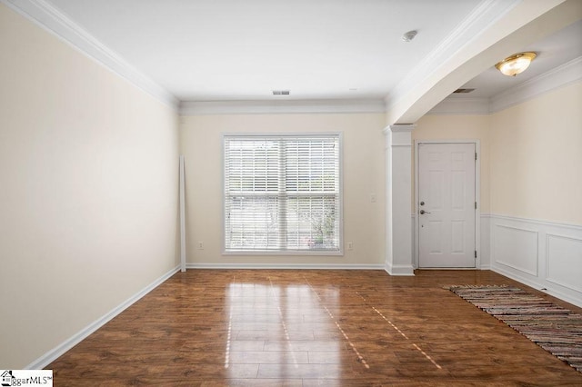interior space featuring decorative columns, visible vents, arched walkways, wood finished floors, and ornamental molding