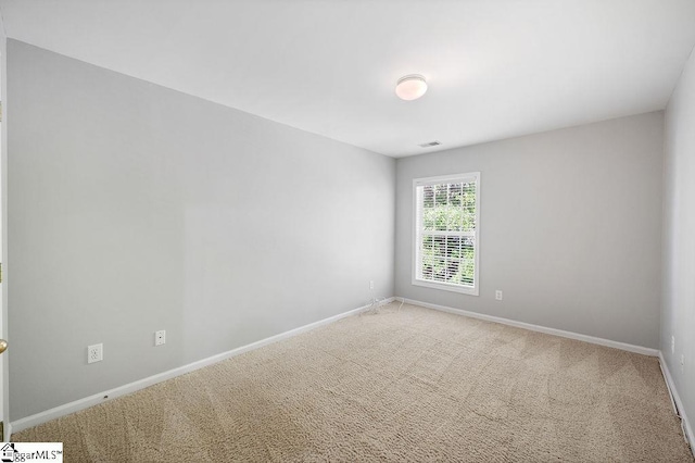 carpeted empty room with baseboards and visible vents