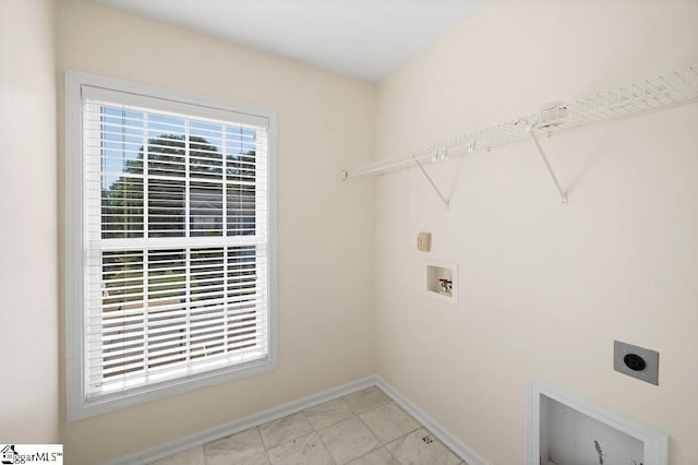 clothes washing area with electric dryer hookup, hookup for a washing machine, baseboards, and laundry area