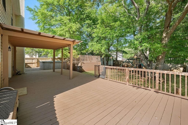 wooden deck featuring a fenced backyard