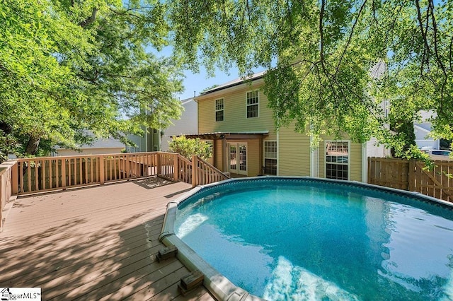 view of pool featuring a deck, a fenced in pool, and fence
