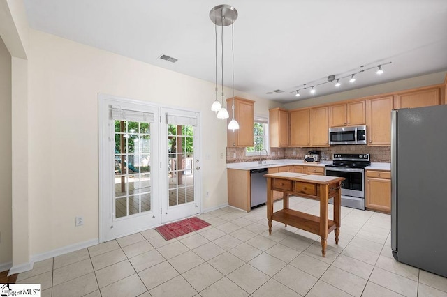 kitchen with backsplash, visible vents, appliances with stainless steel finishes, light countertops, and a sink