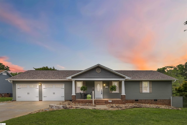 ranch-style house featuring a garage, a front yard, crawl space, concrete driveway, and a porch