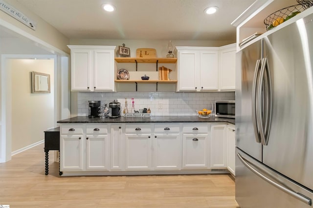kitchen with decorative backsplash, appliances with stainless steel finishes, open shelves, white cabinets, and recessed lighting