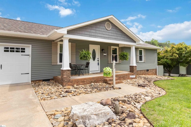 view of front of home featuring covered porch, crawl space, roof with shingles, a garage, and a front lawn