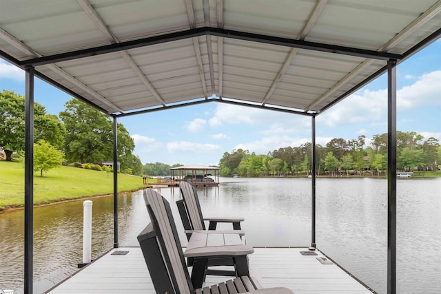 view of dock featuring a water view and a yard
