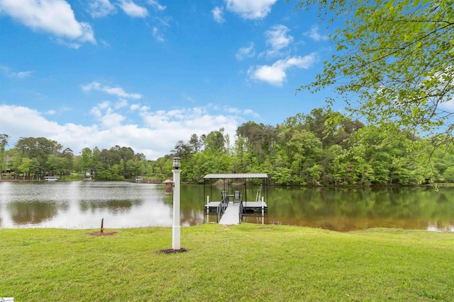 dock area featuring a water view, a yard, and a forest view